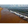 Wave surging on sand on beach