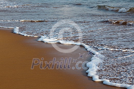 Wave surging on sand on beach Wave surging on sand on beach