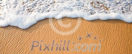 Wave surging on sand on beach. Lots of copyspace Wave surging on sand on beach. Lots of copyspace