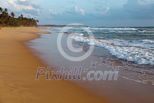 Tropical beach with waves on sunset. Sri Lanka Tropical beach with waves on sunset. Sri Lanka