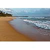Tropical beach with waves on sunset. Sri Lanka