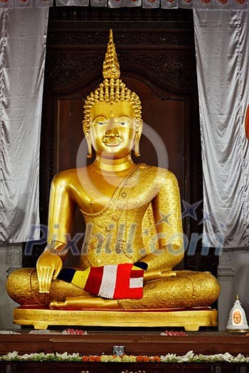 Sitting Buddha statue in Temple of the Tooth. Kandy, Sri Lanka Sitting Buddha statue in Temple of the Tooth. Kandy, Sri Lanka