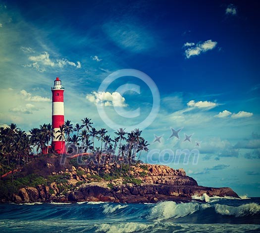 Vintage retro hipster style travel image of old lighthouse and waves of sea. Kovalam (Vizhinjam) Kerala, India Vintage retro hipster style travel image of old lighthouse and waves of sea. Kovalam (Vizhinjam) Kerala, India