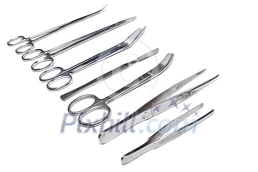 Surgical tools - scalpel, forceps, clamps, scissors - isolated on white background Surgical tools - scalpel, forceps, clamps, scissors - isolated on white background