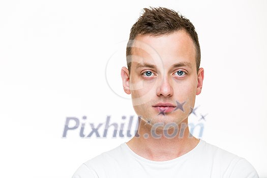 Portrait of a handsome young man, perfectly calm, facing the camera with emotionless expression Portrait of a handsome young man, perfectly calm, facing the camera with emotionless expression