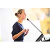 Pretty, young business woman giving a presentation in a conference/meeting setting (shallow DOF; color toned image)