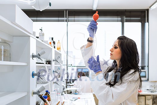 Portrait of a female researcher doing research in a lab (shallow DOF; color toned image) Portrait of a female researcher doing research in a lab (shallow DOF; color toned image)