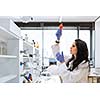 Portrait of a female researcher doing research in a lab (shallow DOF; color toned image)