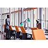 Happy smiling successful African American businessman  in a suit in a modern bright office indoors