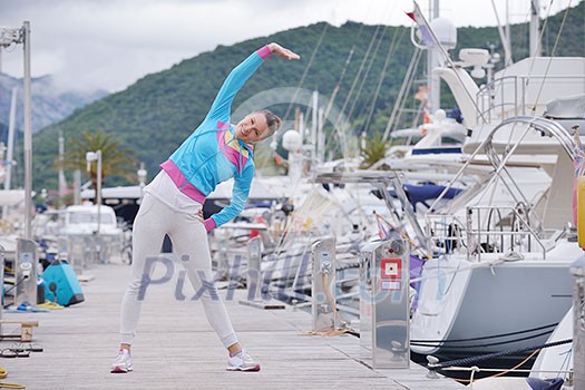 woman jogging at early morning with yacht boats in marina woman jogging at early morning with yacht boats in marina