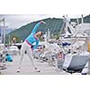 woman jogging at early morning with yacht boats in marina