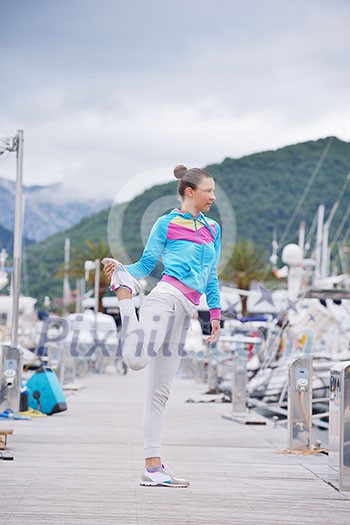 woman jogging at early morning with yacht boats in marina woman jogging at early morning with yacht boats in marina