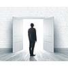 Image of businessman standing in front of opened door