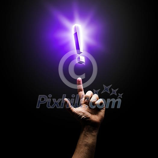 Human hand pointing with finger at exclamation sign Human hand pointing with finger at exclamation sign
