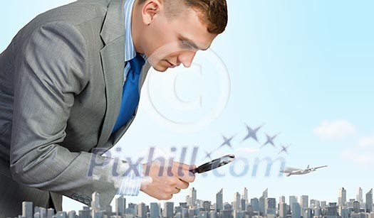 Image of businessman examining objects with magnifier Image of businessman examining objects with magnifier