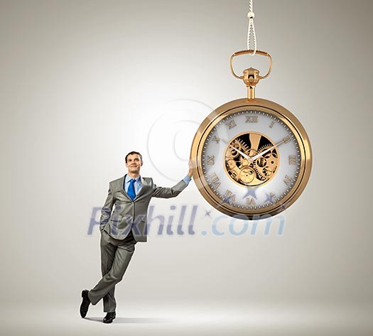 Image of young businessman and pocket watch. Time concept Image of young businessman and pocket watch. Time concept
