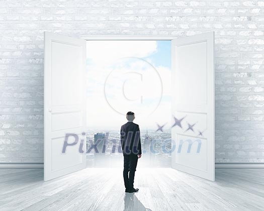 Image of businessman standing in front of opened door Image of businessman standing in front of opened door