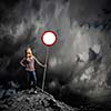 Young woman in casual holding road sign