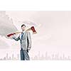 Young businessman holding big axe on shoulder