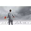 Rear view of businessman holding big axe