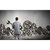 Young businessman with wrench against mechanism background