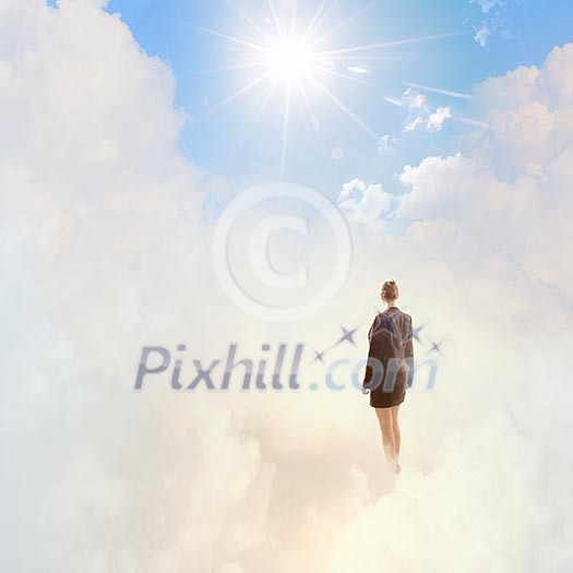 Back view of businesswoman standing on cloud high in sky Back view of businesswoman standing on cloud high in sky