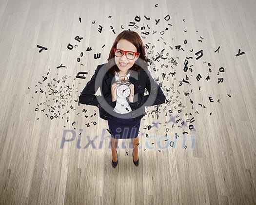 Top view of businesswoman holding alarm clock Top view of businesswoman holding alarm clock