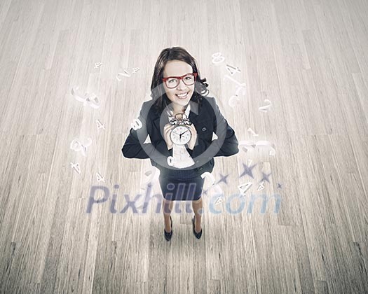Top view of businesswoman holding alarm clock Top view of businesswoman holding alarm clock