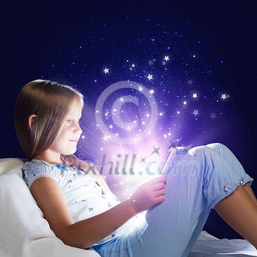 Girl sitting in bed and using tablet pc Girl sitting in bed and using tablet pc