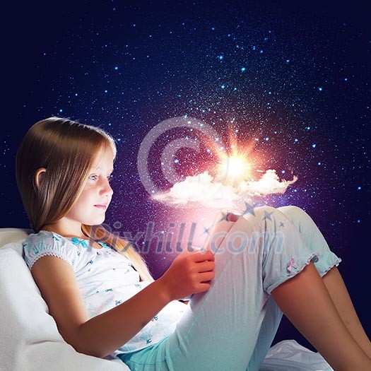 Girl sitting in bed and using tablet pc Girl sitting in bed and using tablet pc