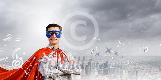 Young confident superman in mask and cape Young confident superman in mask and cape