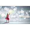 Woman in red dress against bokeh background