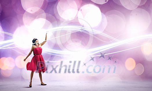 Woman in red dress and blindfold against bokeh background Woman in red dress and blindfold against bokeh background