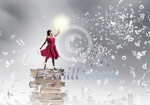 Woman in red dress standing on pile of books Woman in red dress standing on pile of books
