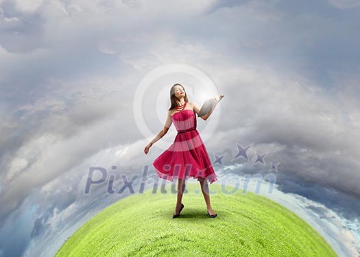 Woman in red dress with book in hands Woman in red dress with book in hands