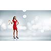 Woman in red dress against bokeh background