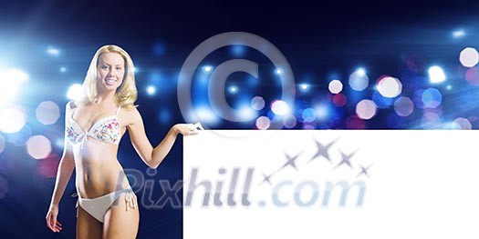 Attractive girl in swimming suit with white blank banner. Place for text Attractive girl in swimming suit with white blank banner. Place for text