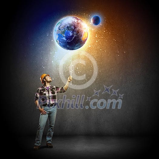 Image of man builder looking at planet Earth. Elements of this image are furnished by NASA Image of man builder looking at planet Earth. Elements of this image are furnished by NASA