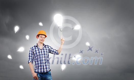 Image of man engineer with bulb. Idea concept Image of man engineer with bulb. Idea concept