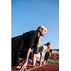 business people running together on racing track