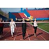 business people running together on racing track