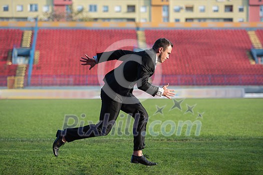 business man in start position ready to run and sprint on athletics racing track business man in start position ready to run and sprint on athletics racing track