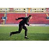business man in start position ready to run and sprint on athletics racing track