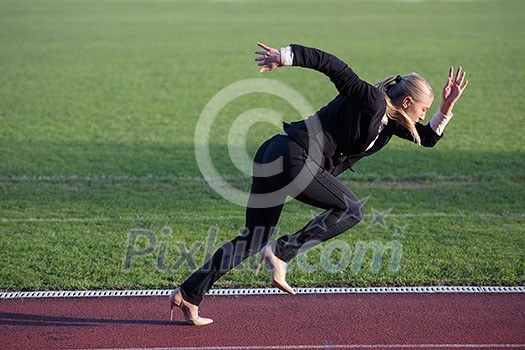 business woman in start position ready to run and sprint on athletics racing track business woman in start position ready to run and sprint on athletics racing track