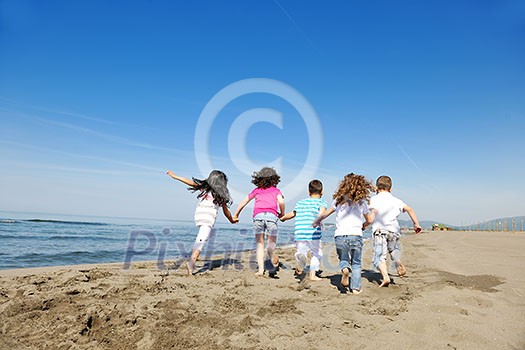 group of happy child on beach who have fun and play games group of happy child on beach who have fun and play games