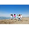 group of happy child on beach who have fun and play games