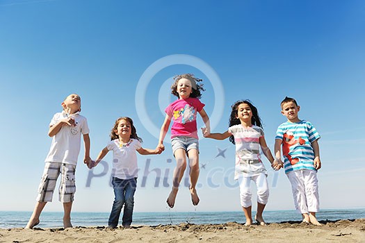 group of happy child on beach who have fun and play games group of happy child on beach who have fun and play games