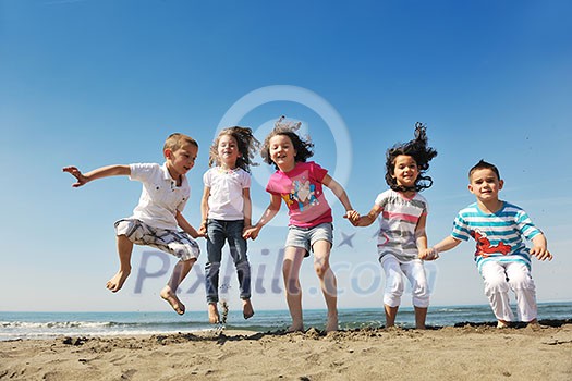 group of happy child on beach who have fun and play games group of happy child on beach who have fun and play games