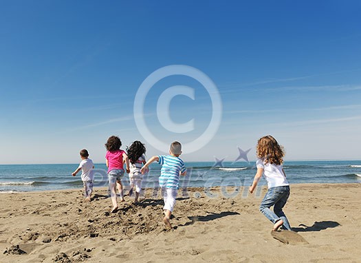 group of happy child on beach who have fun and play games group of happy child on beach who have fun and play games