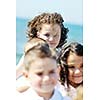 group of happy child on beach who have fun and play games